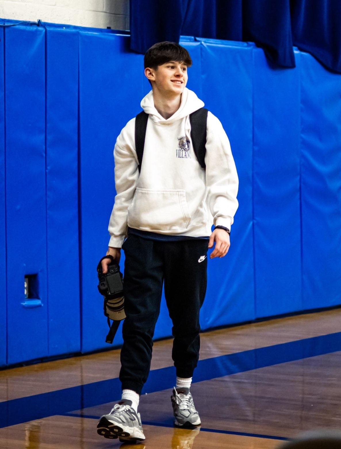 Ryan Heiart on the sideline holding his camera